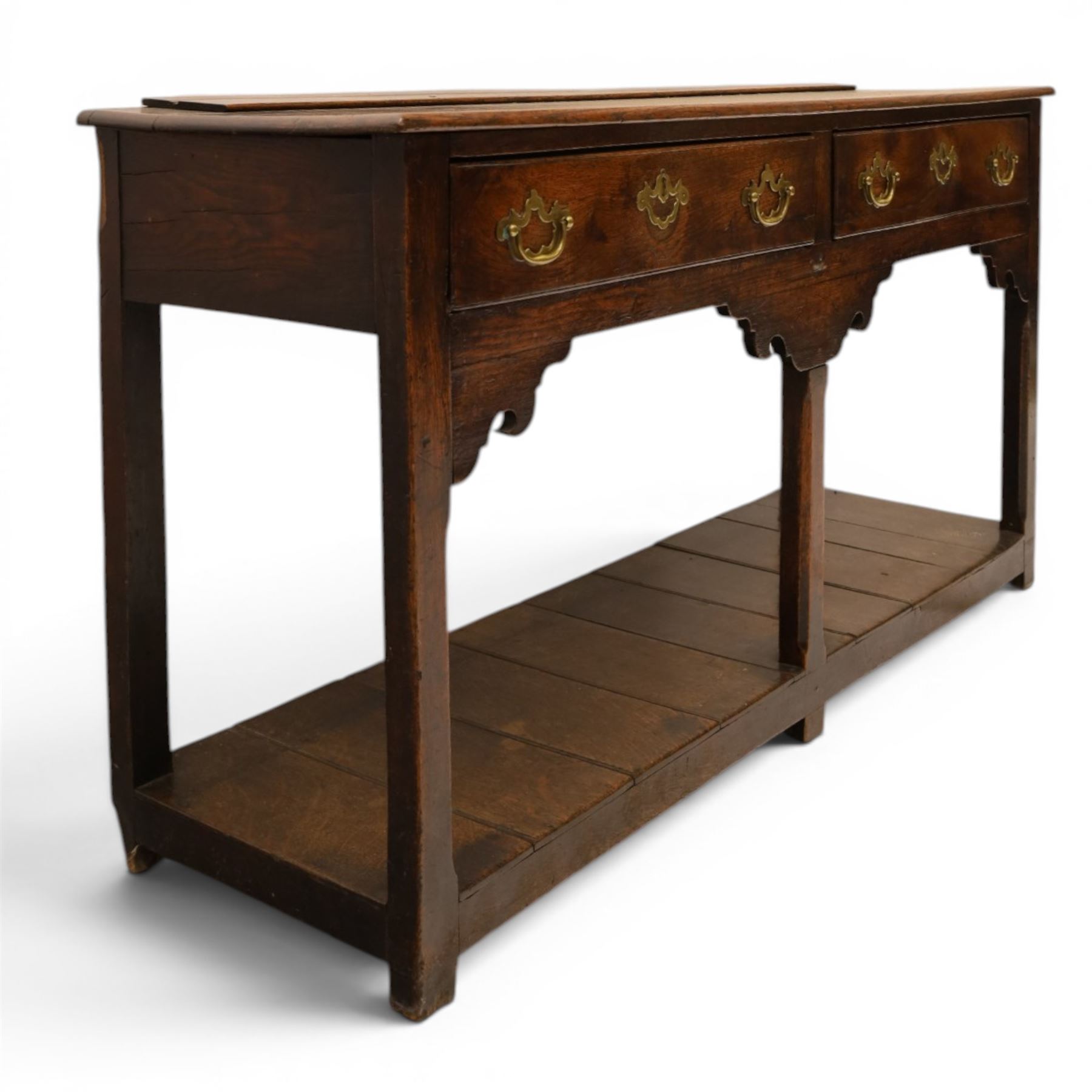 George III oak dresser base, rectangular top with moulded edge, fitted with two drawers over shaped spandrels, raised on square chamfered supports united by undertier, on stile feet