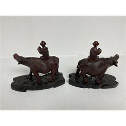 Pair of Chinese hardwood figures of farmers riding water buffalo, on stands, H19cm
