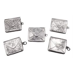 Five early 20th century silver stamp holders modelled in the form of envelopes, comprising three foliate engraved examples, and two plain examples, one with applied detail 'Stamps' verso, hallmarked Albert Ernest Jenkins, (makers mark to one example worn and indistinct),  Chester 1904, 1906, 1908 and 1912, approximate total weight 0.60 ozt (18.6 grams)