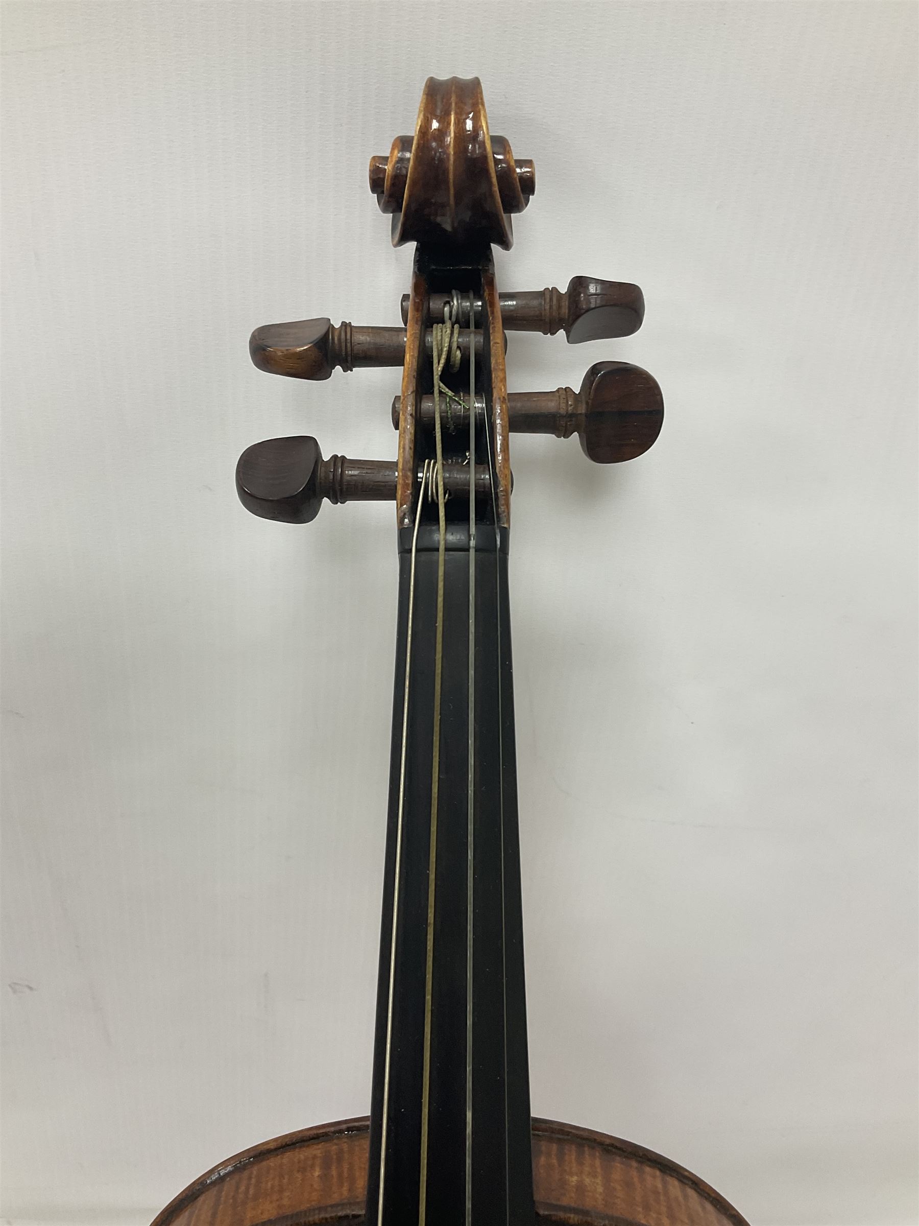 19th century full sized violin in a later hard case, decorative mother of pearl inlay to the tail piece Overall length 60cm No bow
