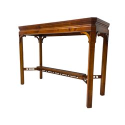 Wade - yew wood console table, rectangular top with canted corners and raised lipped edge, on chamfered square supports united by narrow under-tier
