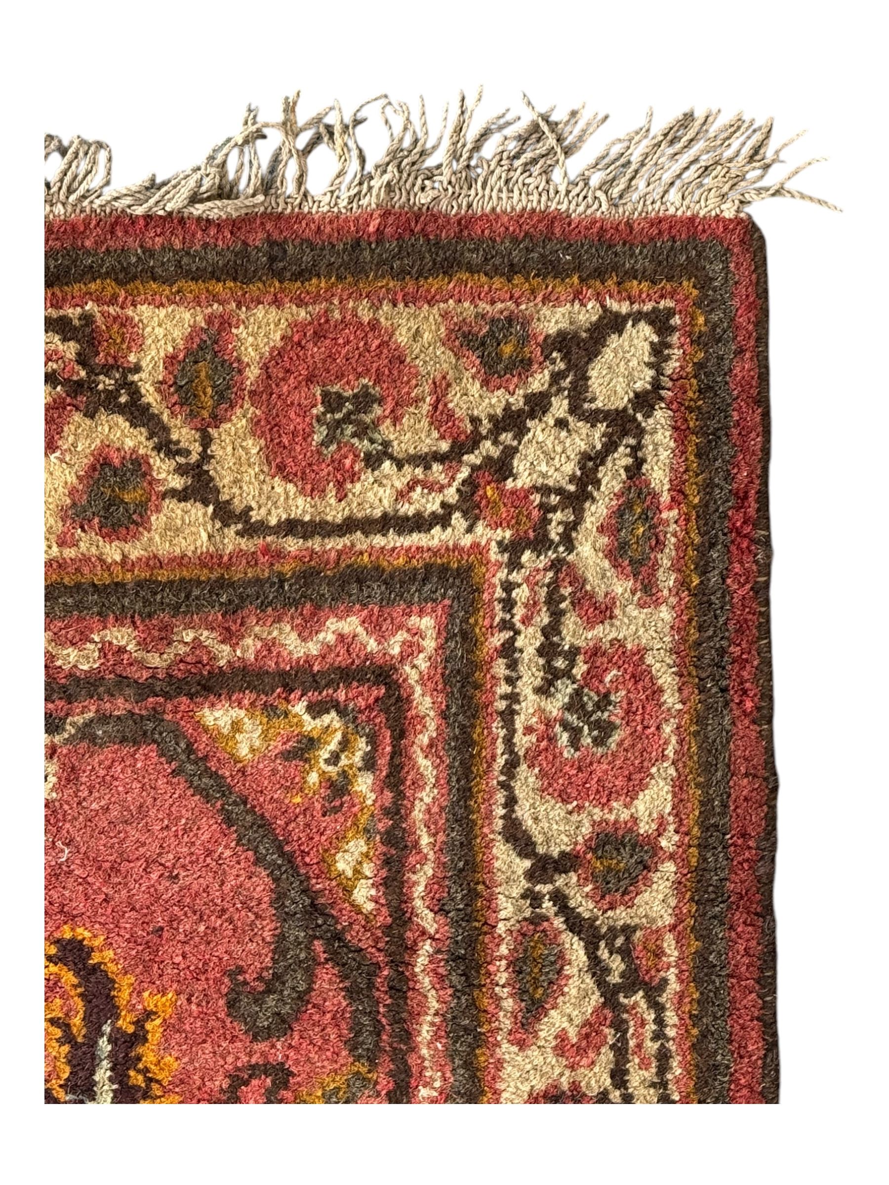 Belgian Sultan woollen ground rug, central navy field densely decorated with floral sprays and geometric patterns (192cm x 135cm); handwoven tribal terracotta ground rug (121cm x 71cm); Persian crimson ground runner, all over stylised floral and foliate motifs (266cm x 94cm)
