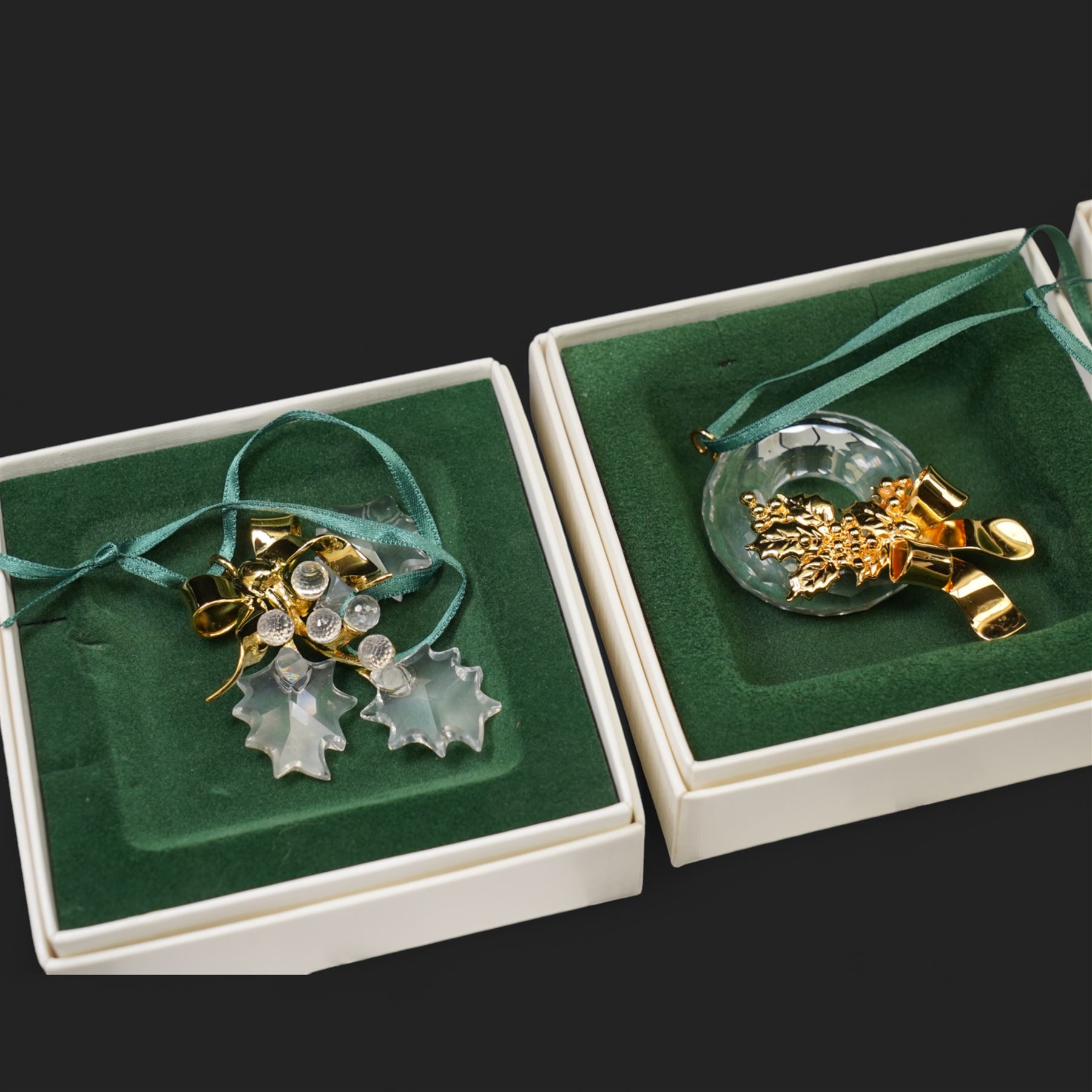 Twelve Swarovski crystal 'Christmas' and 'Crystal' Memories ornaments, comprising Moon, Sun, Boot, Candy Cane, Christmas Wreath, Pinecone and Holly etc, boxed and with sleeves (12)