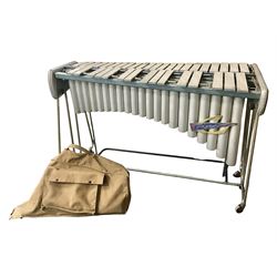 Trixon three-octave vibraphone c1965; with tubular frame, blue panelled ends, four wheels and detachable vibration motor with rubber belts; 1960s Trixon logo to front; serial no.5807; L130cm; together with a selection of various beaters in canvas carrying bag