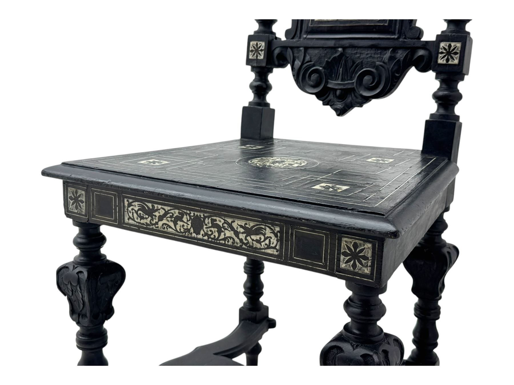 19th century Italian ebonised side chair, the backrest inlaid with bone and decorated with a painted figure in Renaissance dress within an arched reserve, flanked by turned supports and scrolled cresting, the seat and frieze similarly inlaid, raised on turned legs with shaped stretchers