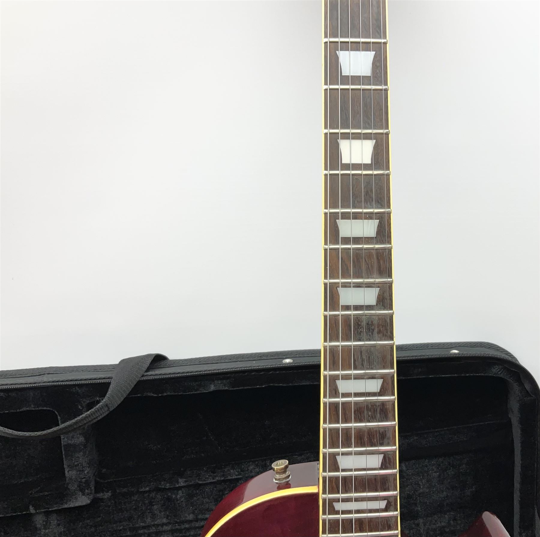 1980s Les Paul Epiphone limited edition cut-away electric guitar by Gibson, the burgundy coloured body with two pick-ups, volume and tone knobs and scratch plate, original tuning pegs, serial no.U6030215, 101cm overall; in modern Kinsman fitted carrying case