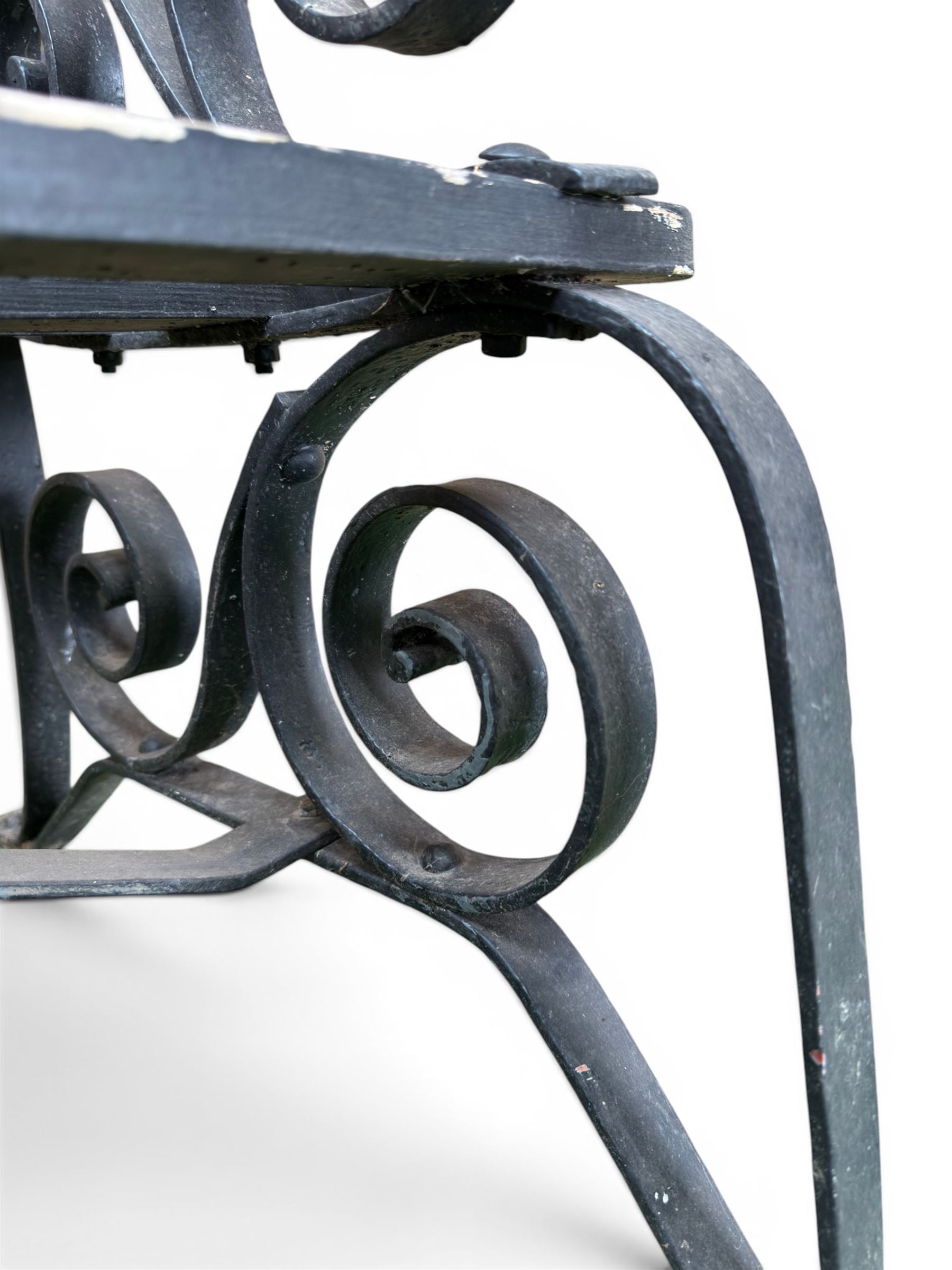 Coalbrookdale - rare pair of wrought iron and slatted wood garden benches, the twin wrought iron strapwork bench-ends formed of four scrolls over splayed feet, number 77 in the Coalbrookdale Castings Catalogue (see illustration)