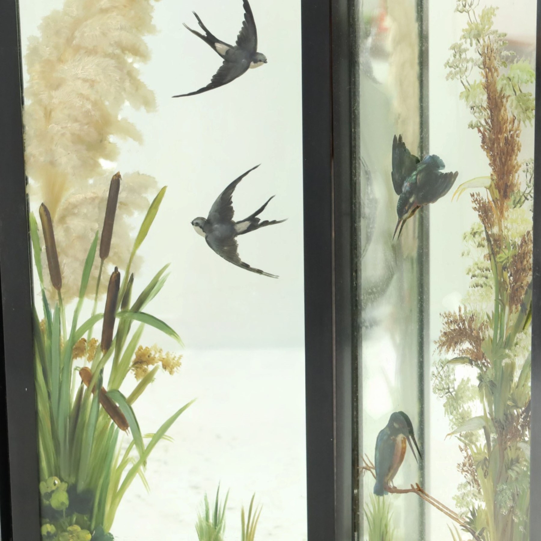 Late Victorian Aesthetic Movement ebonised and painted three-panel folding mirror screen, spindle gallery cresting rail over three rectangular mirror plates painted with floral pond scenes with lily-pads, swallows and kingfishers, each panel W37cm H110cm)