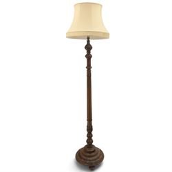 Late 19th Century mahogany standard lamp with shade, canvas beige shade, above a carved an...