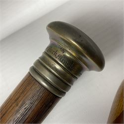 Three early 20th century walking sticks, to include a smoking pipe walking stick, the cane opening to reveal a concealed pipe, and a wooden walking cane, the metal cover with inscription 'bell metal and wood of York Minster, Burnt May 20 1840, and a turned wooden walking stick, with marquetry checkerboard pommel, tallest L90cm