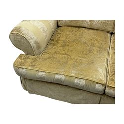 Contemporary two-seat sofa, upholstered in damask fabric with a pale gold floral pattern, rolled arms with covers, loose back and seat cushions, on matching skirted base with concealed castors
