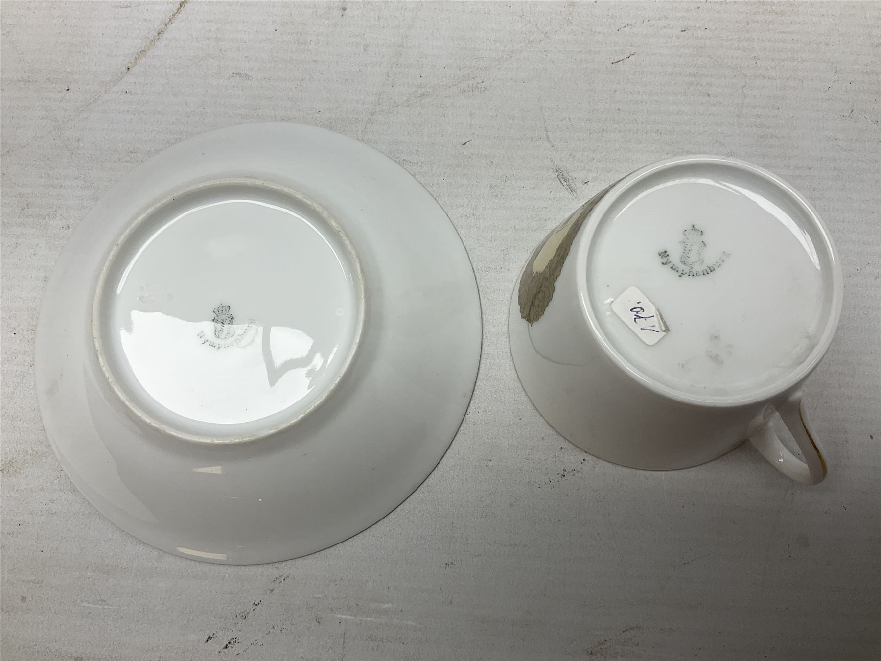 WW2 Nymphenburg cups and saucer, decorated with Imperial German Iron Cross encircled in a foliate boarder with gilt edging, with printed mark beneath 