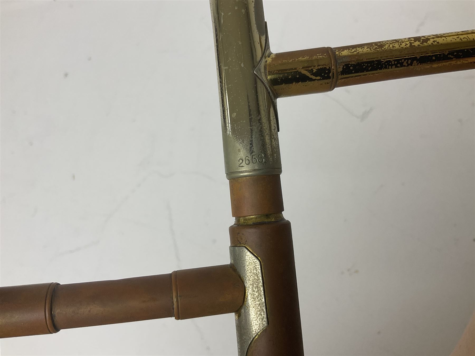 Three brass trombones comprising Elkhart Ind. USA 'CONN' model no.72H; Besson 'Concord'; and Selmer Distributed 'Lincoln'; two in carrying cases; and German B & M 'Champion' brass trumpet (4)