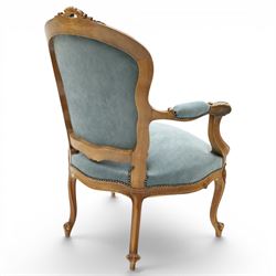 Louis XV design giltwood open armchair, shaped upholstered back with carved foliate cresting, padded scroll arms and serpentine seat upholstered in pale blue fabric with studwork, moulded and foliate carved frame, on cabriole supports with scroll feet