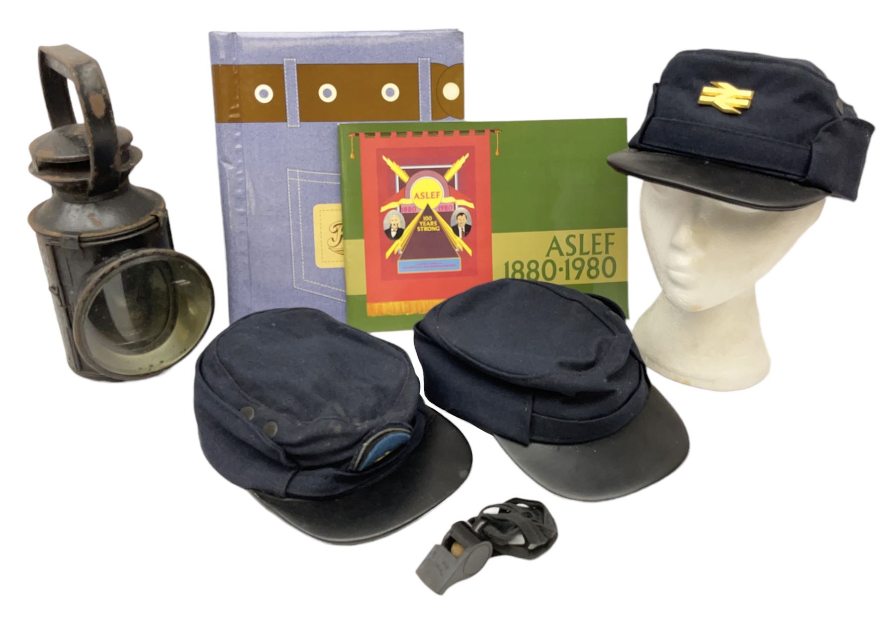 Black painted three colour railway lamp with revolving filters, H29cm; BR Acme Thunderer whistle; three railway peaked caps, two with BR Intercity 125 badge; small album of photographs of railway interest etc