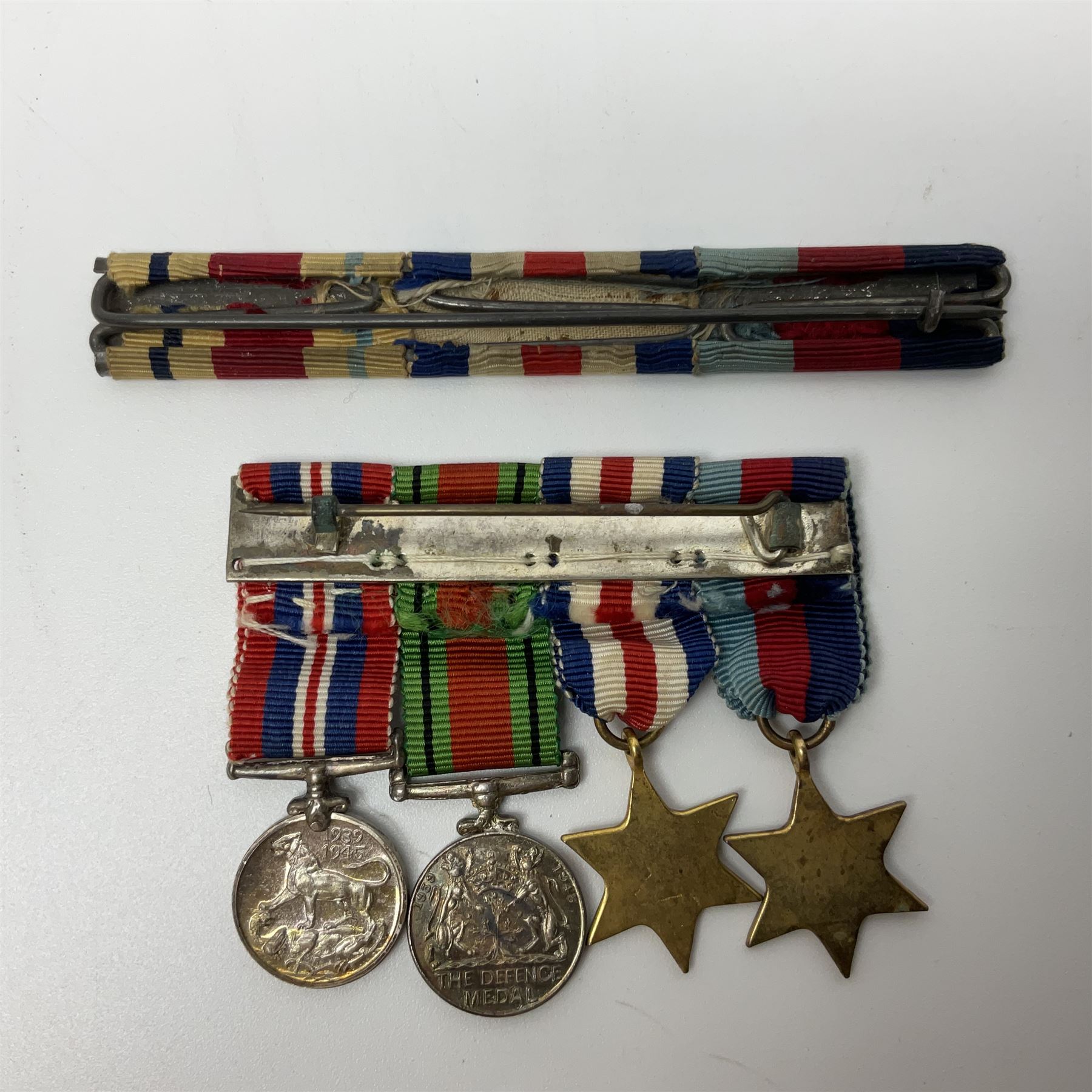 Ten WW2 medals comprising two 1939-1945 war medals, two Defence medals, two 1939-1945 Stars, two Africa Stars, France & Germany Star and Burma Star; together with bar of four miniature medals; all with ribbons