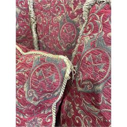 Large Knole design hardwood-framed three-seat drop-arm sofa, upholstered in crimson fabric decorated with trailing acanthus leaves and shields, together with scatter cushions 