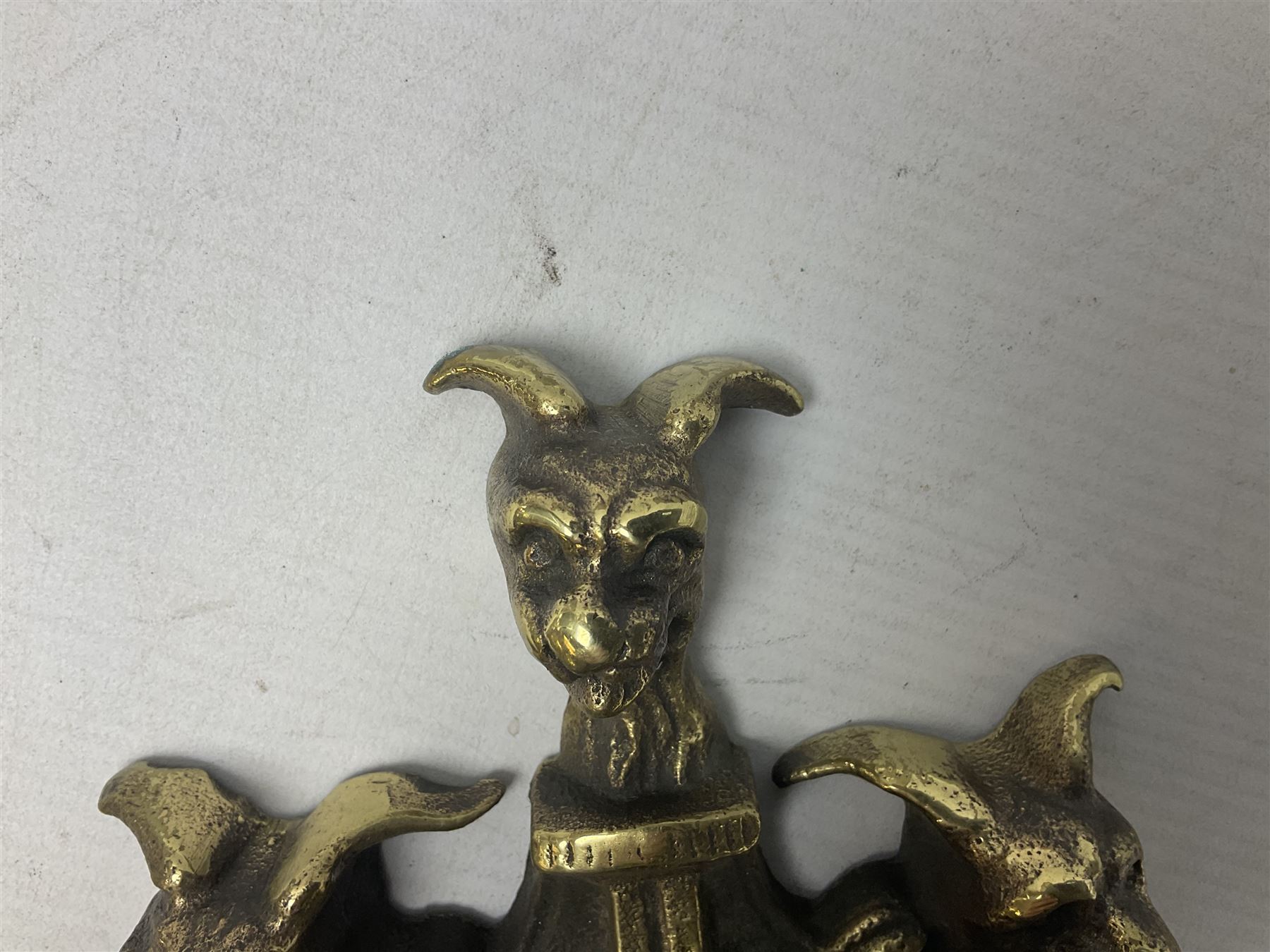 Gothic style cast brass door knocker, modelled with the Greek three-headed hell hound Cerberus on Rococo style base with central knocker of tear drop above Hades, God of the underworld, L29cm