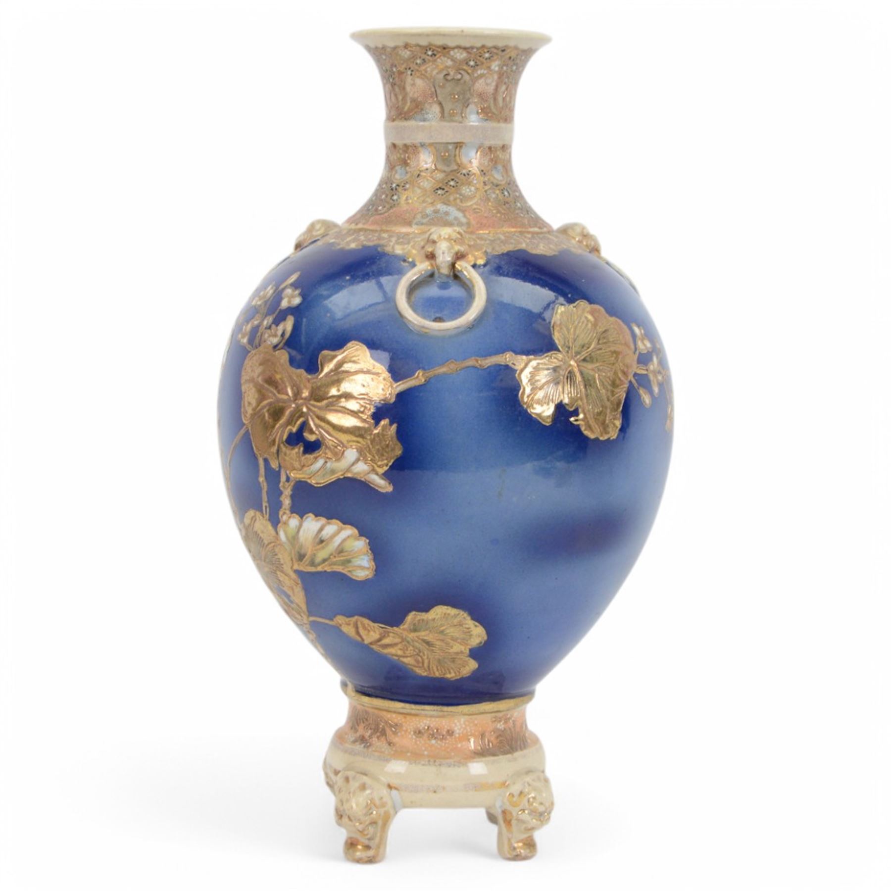 Japanese Satsuma vase, of ovoid form with wasted neck, and three applied mask mounted ring handles, upon four mask detailed feet, the blue ground body painted with blossoming vines, with painted gilt mark beneath, H38cm