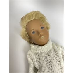 Sasha Morgenthaler 'Gregor' vinyl doll, the boy's head with painted blue eyes and lips and blonde hair, the jointed body donning a white turtleneck knitted jumper and blue knitted trousers, unmarked, H41cm