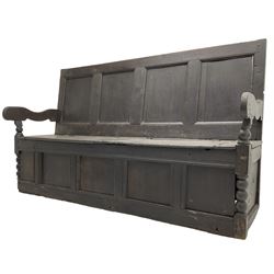 18th century oak box seat settle bench, pegged construction with quadruple panelled back over double hinged box seat, shaped projecting arms with scroll carved terminal detail, on block and bobbin turned front supports, panelled front within moulded frame