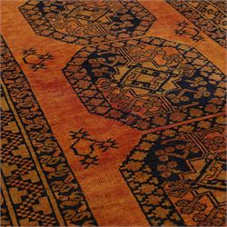 Afghan Ersari hand-knotted rug, apricot field decorated with three large octagonal gul medallions filled with geometric floral motifs, flanked by small tribal devices, end fringe fraying 97x167cm, together with a Baluch prayer rug, decorated with stylized tree motifs arranged in vertical rows beneath a stepped mihrab arch with multiple narrow borders of angular tribal motifs in shades of indigo, brown, and ochre fraying to flatweave ends, 134x84cm, (2)