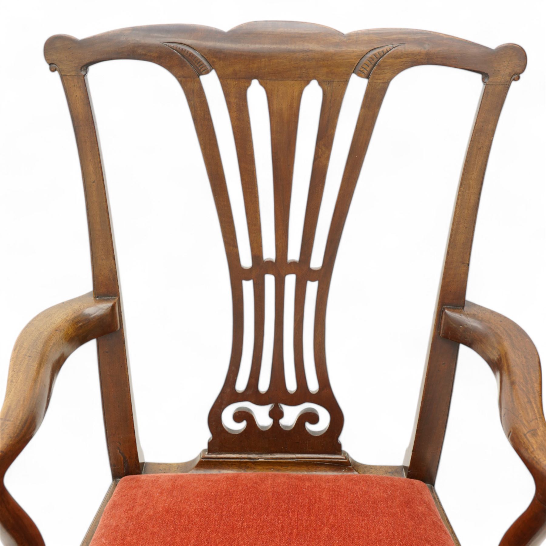 George III mahogany open elbow chair, shaped cresting rail over pierced splat, shaped arms with scroll carved terminals, drop-in seat upholstered in red fabric, on square supports with moulded edge united by plain stretchers 