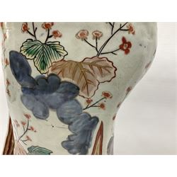 Large Japanese Imari porcelain figure, modelled as a Bijin, wearing a long kimono decorated with apple blossom and leafy branches on a white ground, with gilt detailing, possibly Edo period, H63cm