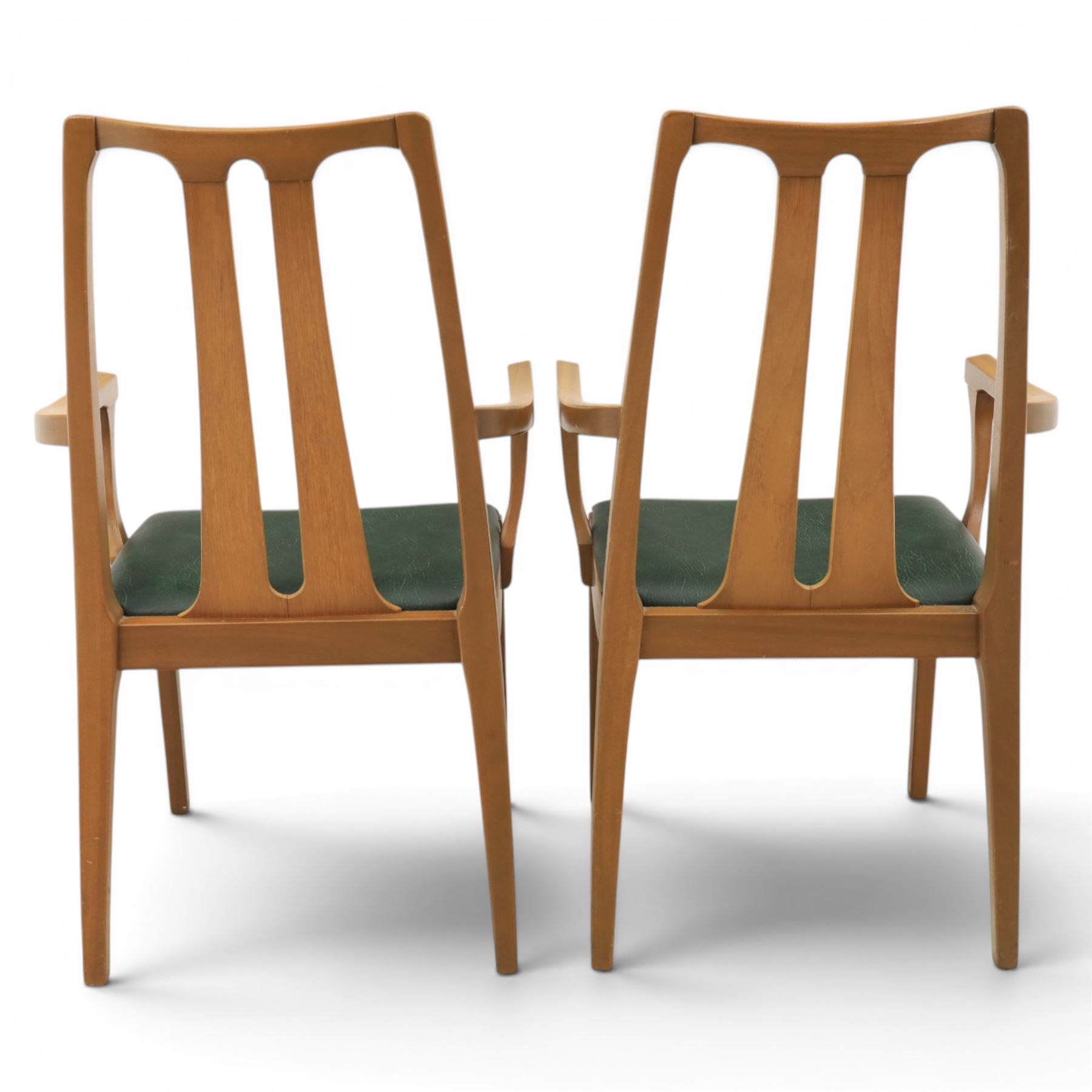 A pair of Nathan 'Highback Carvers' and a 20th century nest of teak tables, (Tables W65cm, D38cm, H49cm)
(Carvers W57, H97)