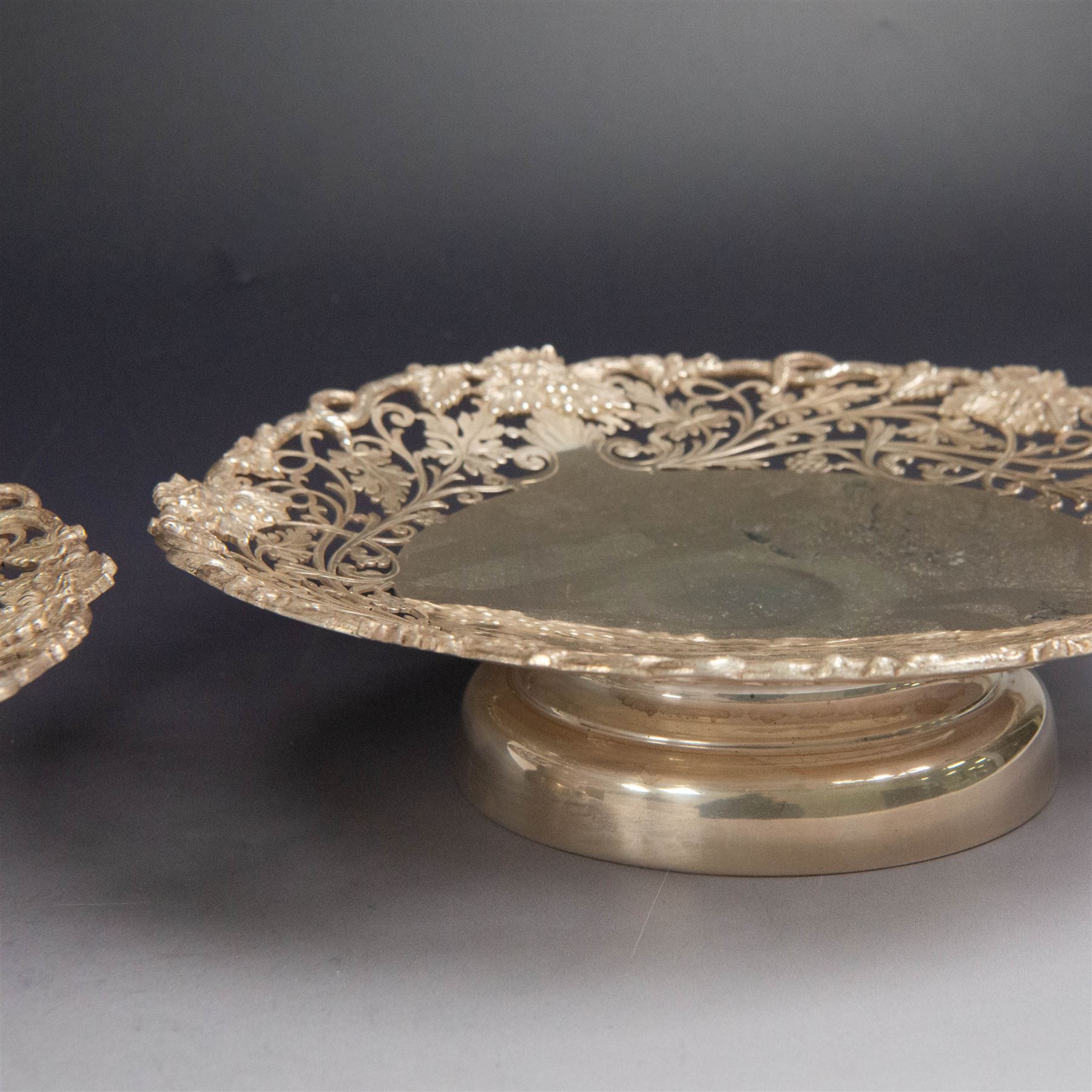 Pair of 1930s silver pedestal dishes, of circular form, the sides with pierced vine decoration, upon a domed pedestal foot, hallmarked Lee & Wigfull, Sheffield 1938, D21cm, H6cm