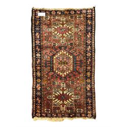 Belgian Sultan woollen ground rug, central navy field densely decorated with floral sprays and geometric patterns (192cm x 135cm); handwoven tribal terracotta ground rug (121cm x 71cm); Persian crimson ground runner, all over stylised floral and foliate motifs (266cm x 94cm)