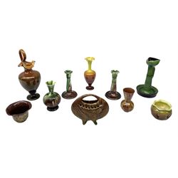 Linthorpe pottery vase with crimped rim and ovoid body, Linthorpe jug with high loop handle and crimped spout, a pair of candlesticks with a green, brown glaze and other similar pottery 