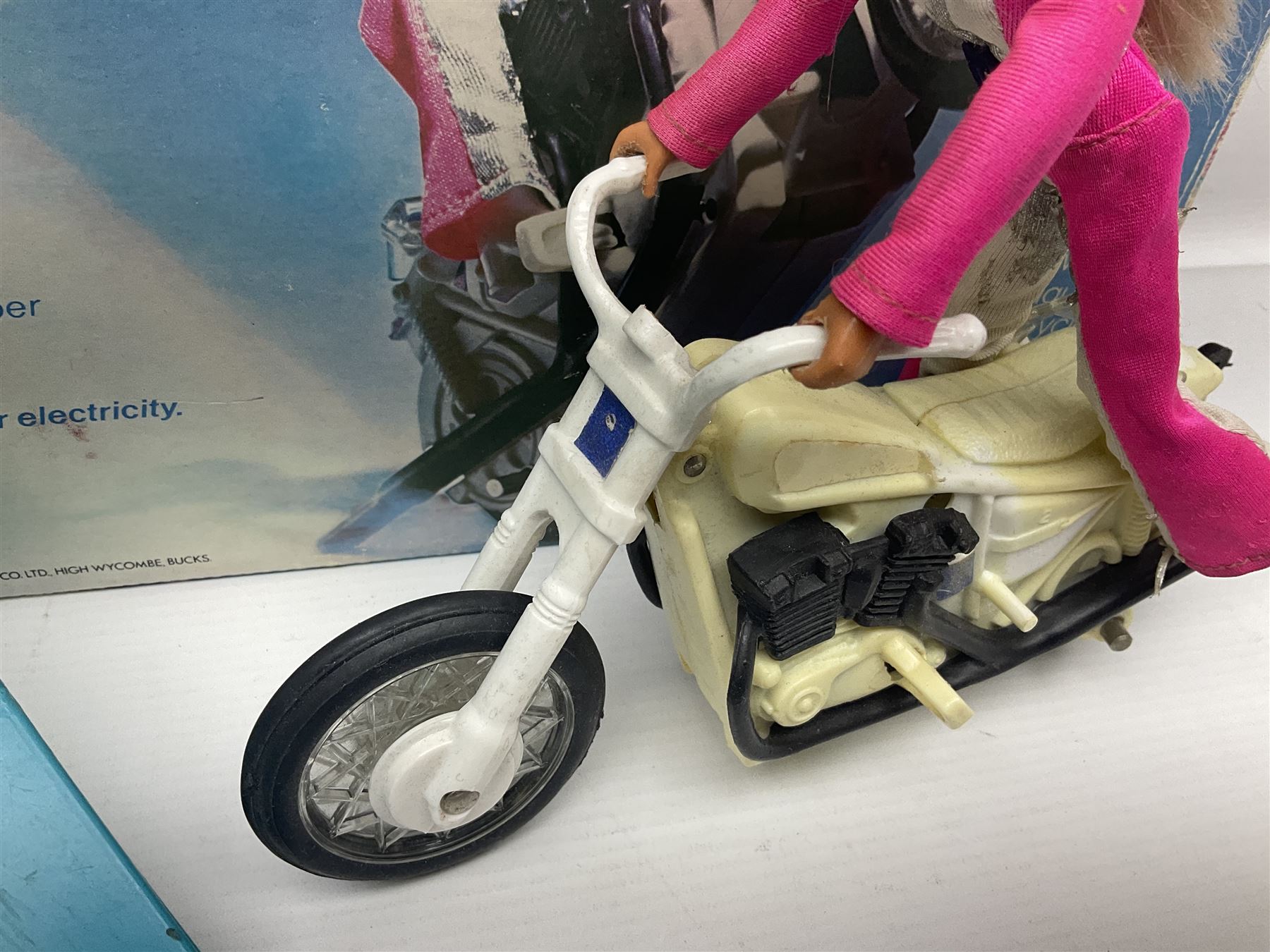 Ideal Derry Daring and Her Trick Cycle, with clothed figure on trick cycle and winder; in original illustrated box dated 1975