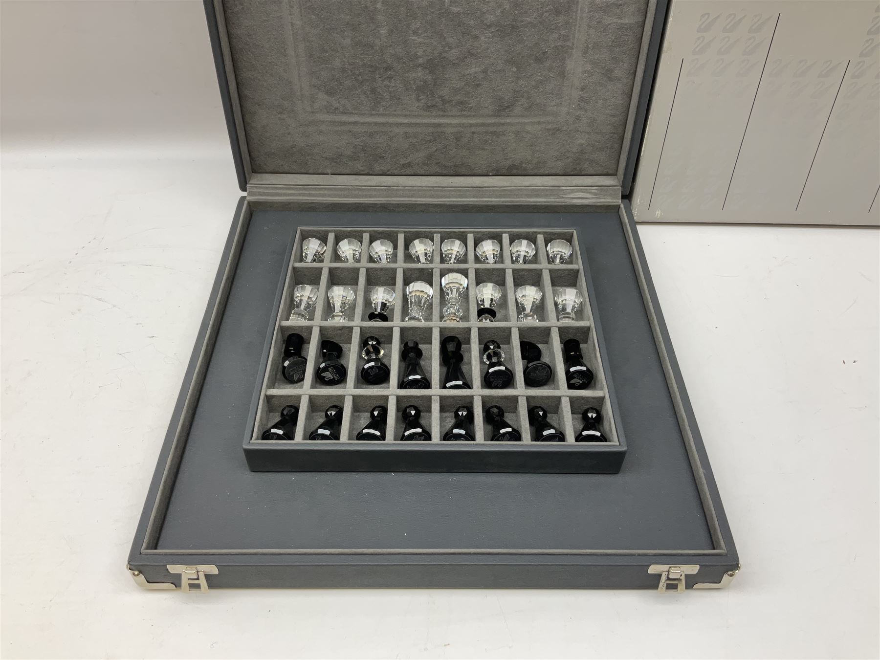 Swarovski silver crystal cut glass chess set, with clear and black pieces on mirrored board, in original presentation box 