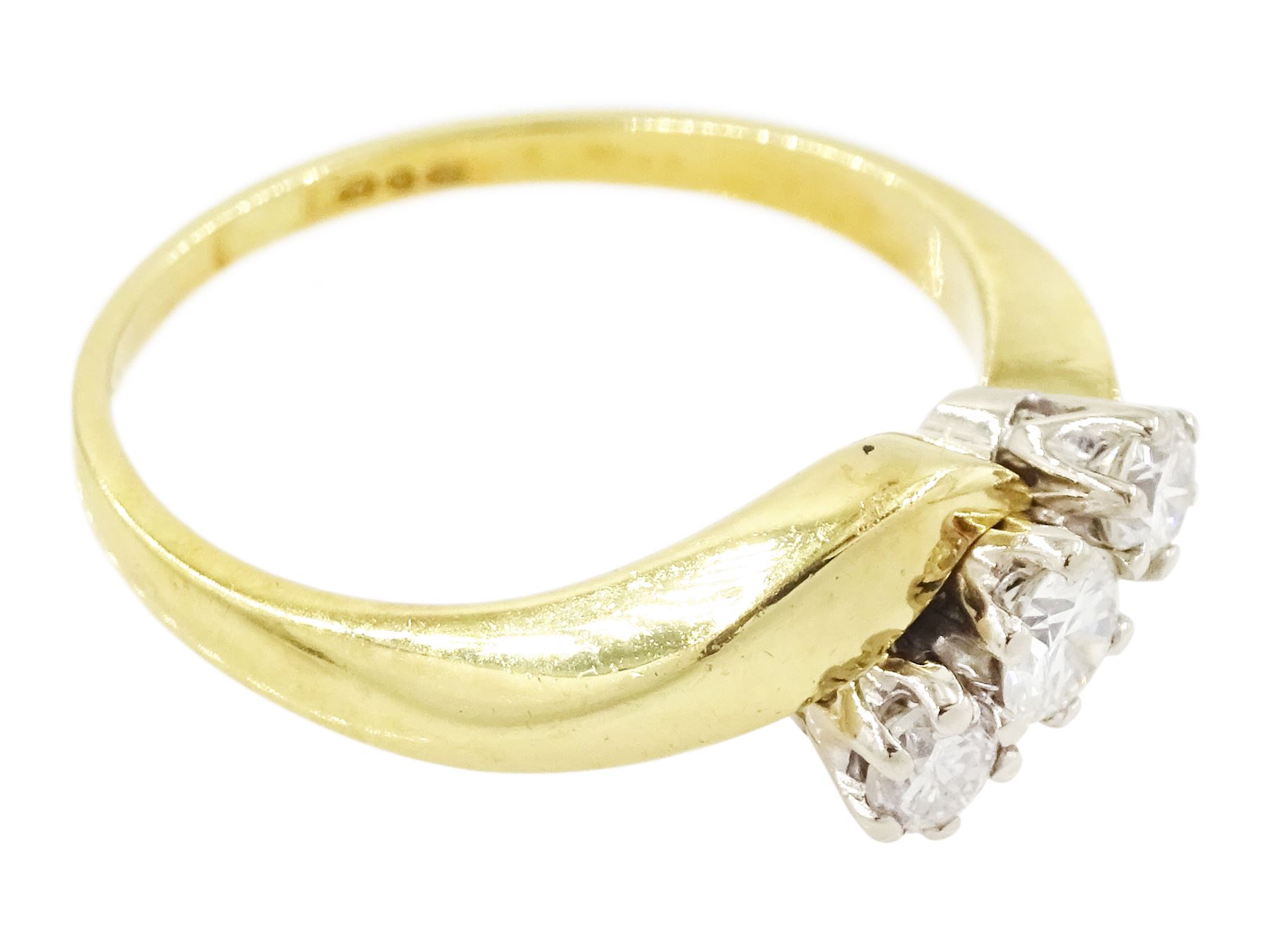 18ct gold diamond crossover ring, set three round brilliant cut diamonds, London 1991, total diamond weight 0.35 carat