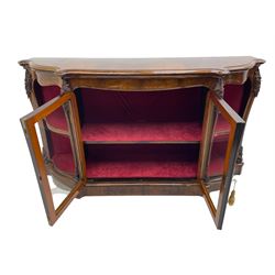 19th century rosewood buffet credenza, bombe form with shaped and moulded top, two central glazed doors with foliate moulded gilt slips, the red fabric-lined interior fitted with a single shelf, flanked by open shelves with raised gilt metal lips, the uprights decorated with shell and flower head carved cartouche mounts, acanthus leaf scroll carved lower mounts, on shaped and moulded plinth base 