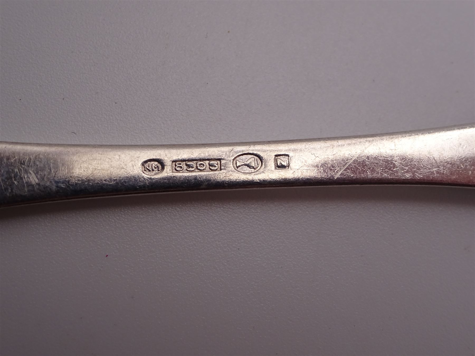 1930s Norwegian silver cutlery for six place settings, comprising table spoons, table forks and silver handled table knives, cake forks, tea spoons and demitasse spoons, one cake slice, serving spoon, sauce ladle and a pair of silver handled servers, all embossed with rose decoration and engraved with initial K to terminal and 10/9 1932 verso, stamped NM 830s