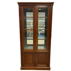 Grange Furniture - cherry wood finish display cabinet, two bevel glazed doors enclosing mirrored interior with glass shelves, double panelled cupboard below, on plinth base