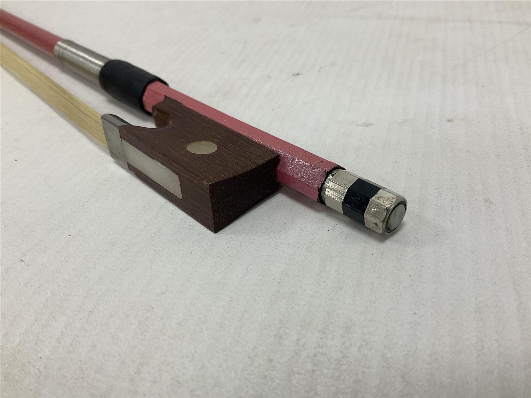 Zest full size pink violin, with a solid wood body and maple head, with matching pink bow and two further bows, in a hard case Length 60cm