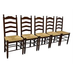 Set of ten 18th century design oak ladder back dining chairs, shaped cresting rail over four horizontal splats, rush seat raised on turned supports united by double stretchers