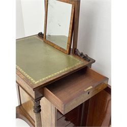 Early Victorian figured mahogany dressing cabinet, the raised shell and scroll carved back lifts to reveal rectangular easel mirror with mahogany band, flat rectangular top with tooled leather inset, slide at each side with matching leather inset, full width drawer above cupboard enclosing a series of five drawers, turned front supports, panelled front, sides and back