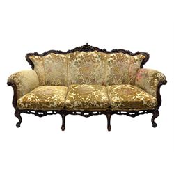 Victorian design stained wood three seater settee, top rail carved and scrolled, padded back and arms, scrolled cabriole feet 