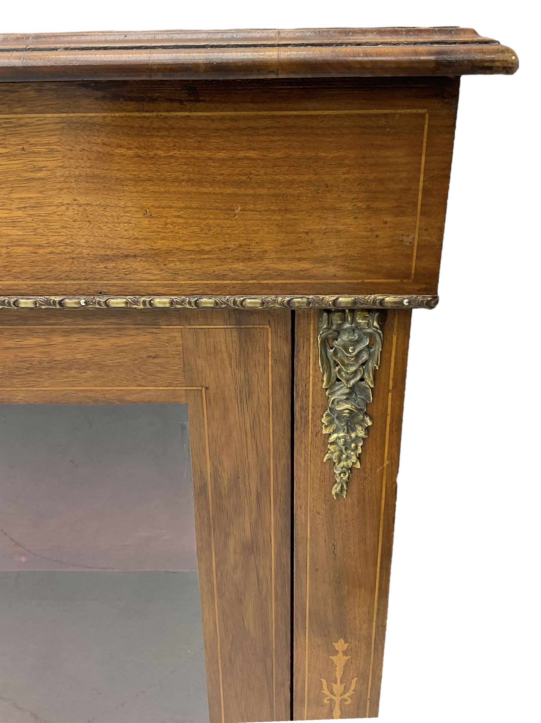 Victorian walnut pier cabinet, moulded rectangular top over inlaid frieze, decorated with gilt metal mounts and beading, the glazed single door flanked by inlaid uprights, on moulded plinth base