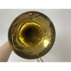 Three brass trombones comprising Elkhart Ind. USA 'CONN' model no.72H; Besson 'Concord'; and Selmer Distributed 'Lincoln'; two in carrying cases; and German B & M 'Champion' brass trumpet (4)