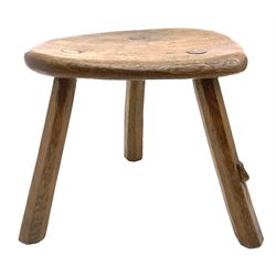 ‘Mouseman’ oak stool with shaped dished top on three tapered octagonal supports, carved with mouse signature, by Robert Thompson of Kilburn