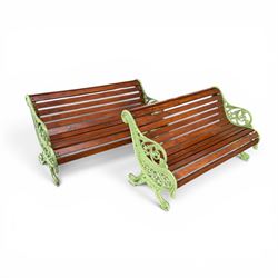 Pair of Victorian design cast iron and slatted wooden garden benches, the ornate pierced end supports of scrolled form, the pierced acanthus leaves interspersed with trailing flowerheads, with tassels to the front, raised on splayed feet, the supports in pale sage green painted finish