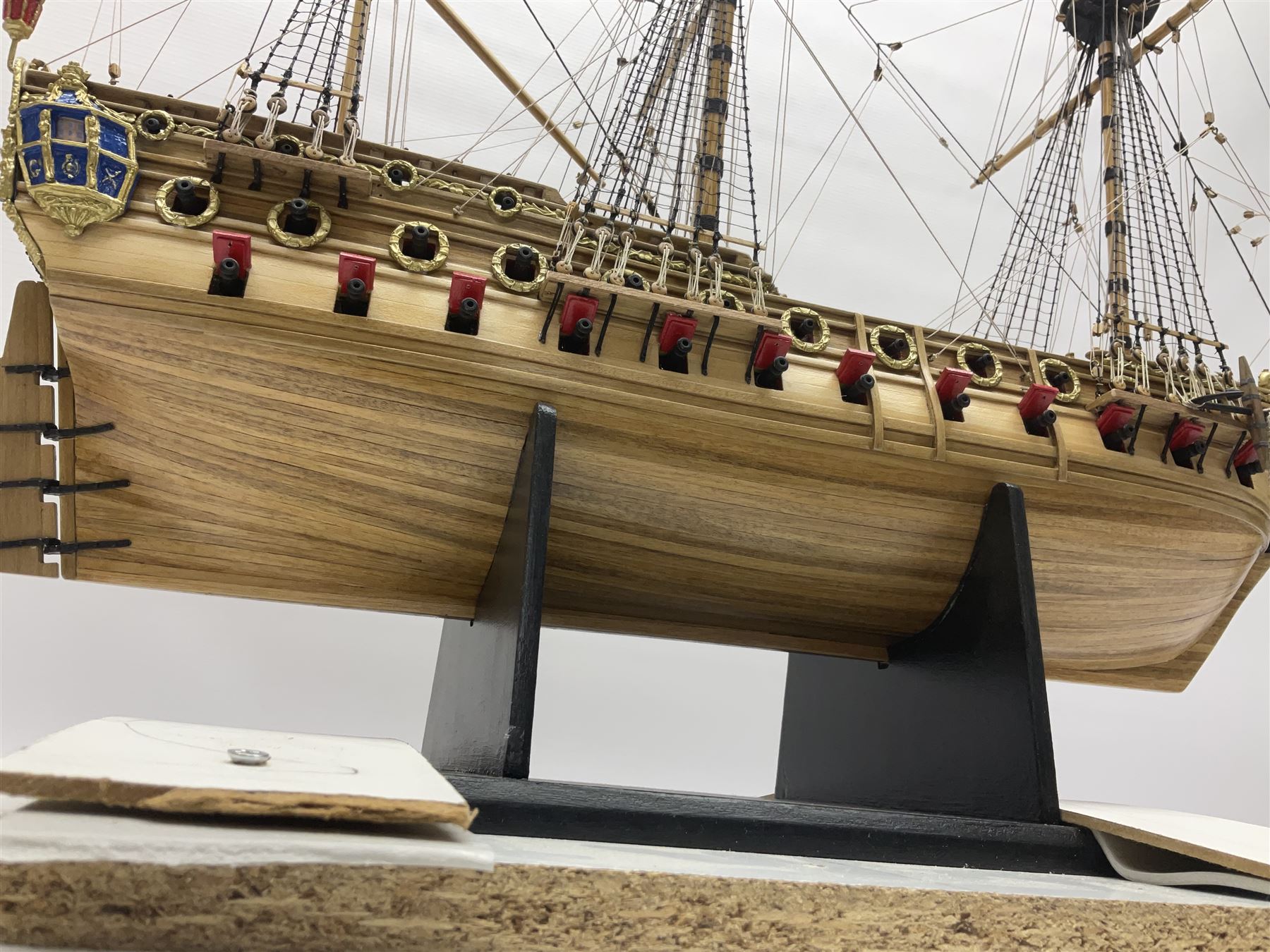 Wooden kit built model of HMS Neptune, 1:90 scale, with detailed rigging to three masts and a row of cannons to either side, upon ebonised wooden base, including stand H71cm