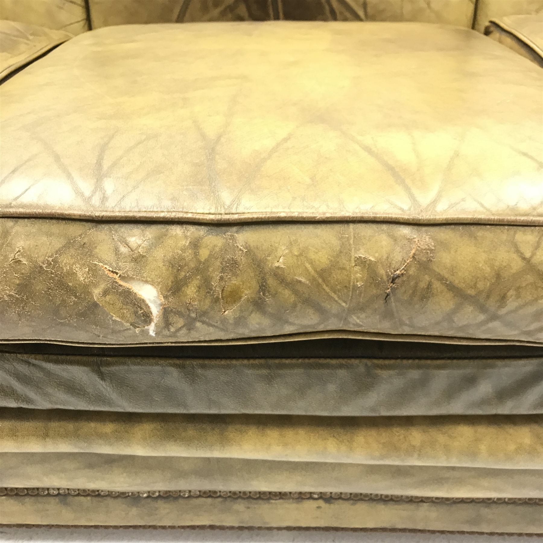 Vintage Knole three seat drop arm sofa upholstered in green studded leather, W230cm