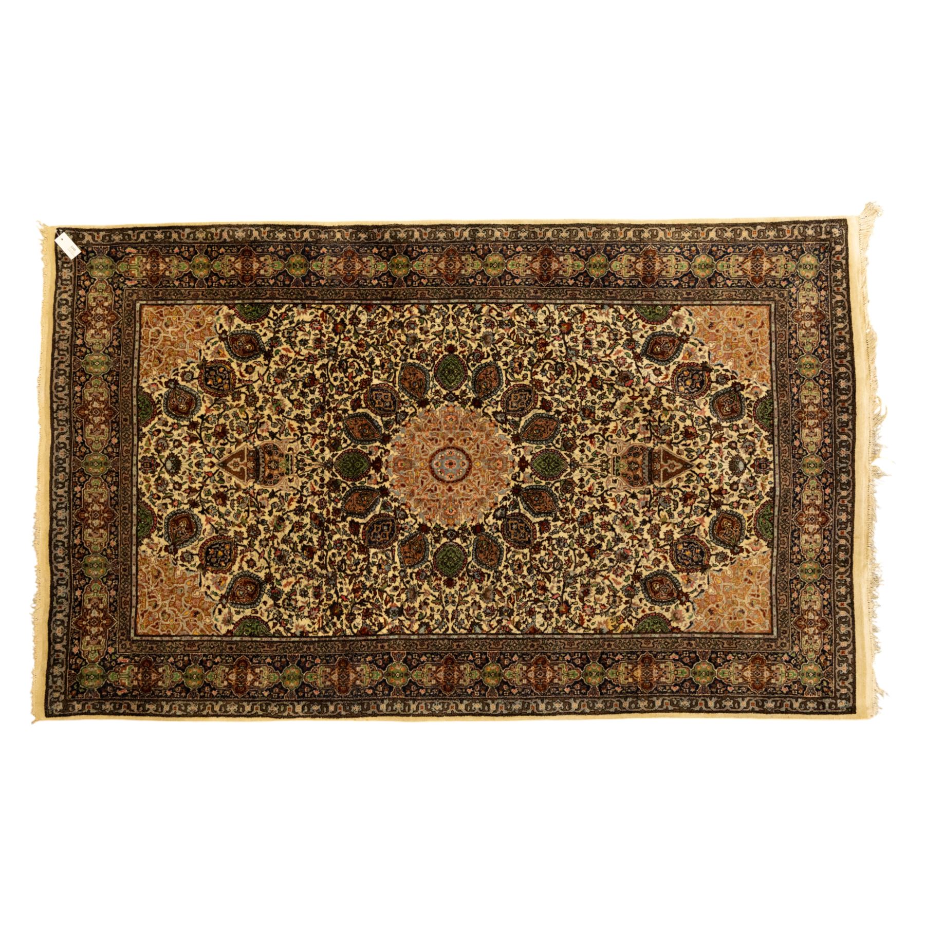 Persian Nain hand-knotted rug, central circular medallion with radiating floral scrolls and palmettes enclosed by ivory field with boteh and foliate motifs, framed by a series of guard stripes and a main border with scrolling arabesques in a midnight blue ground 