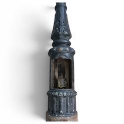 REVO Electric Co. Ltd., Tipton - early 20th century cast iron street lamp standard, the later hexagonal lantern with amber leaded glazing and pointed finial, supported on a swan-neck bracket above a ring-turned capital, tapering column and ladder rest, terminating in a moulded scrolling foliate-decorated base with lappet collar, stamped REVO

Provenance: formerly installed as street lighting in Prestwich, Greater Manchester